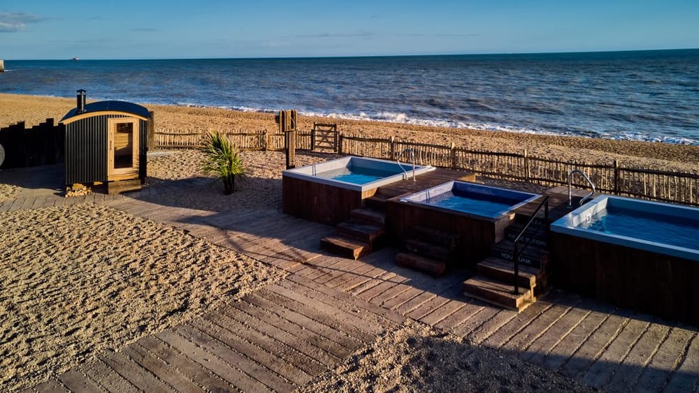 The beach spa at Folkestone — a sauna cabin and seawater plunge pools by the shore